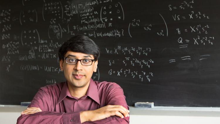 Faculty sitting near chalkboard