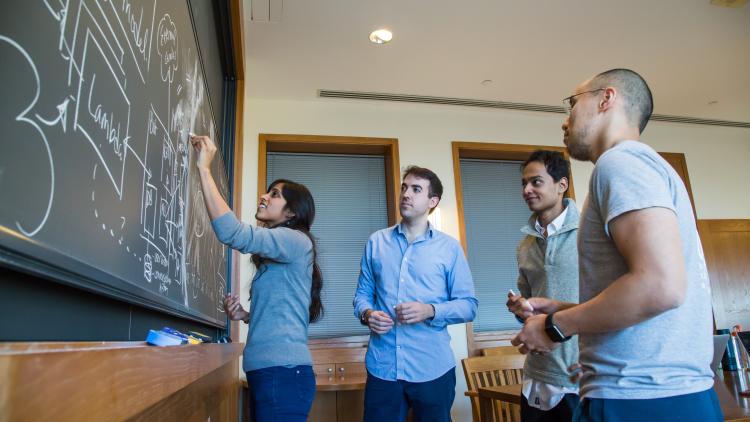 Students Writing on Chalkboard
