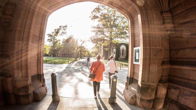 Students walking through archway