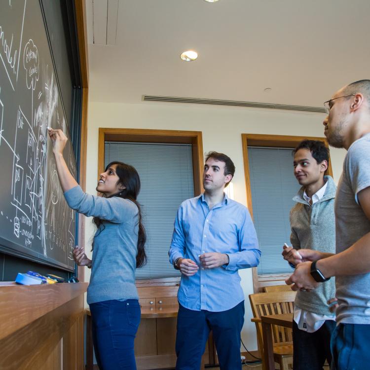 Students Writing on Chalkboard