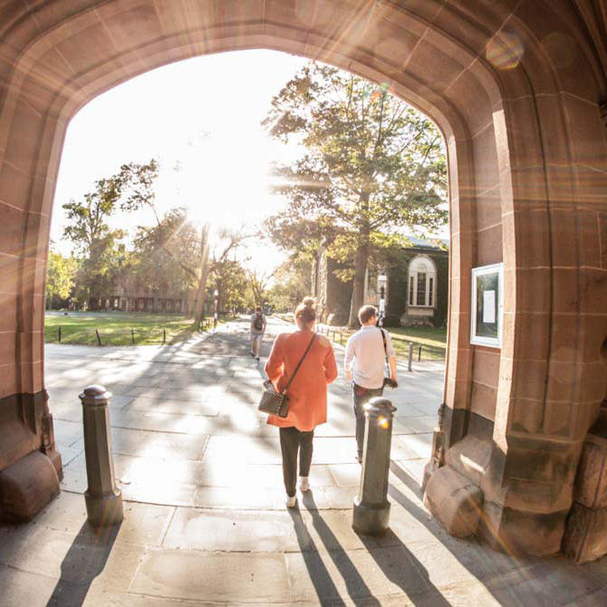Students walking through archway