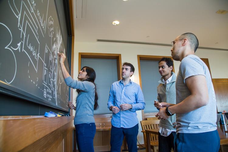 Students Writing on Chalkboard