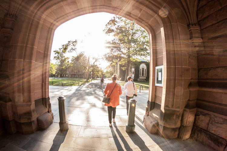 Students walking through archway