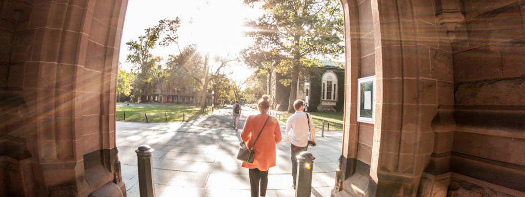 Students walking through archway